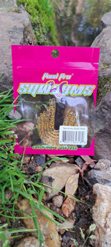 Pond Pro Package of Gold Flake Sqworms on a rock near water.