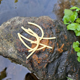 Pond Pro Sqworms on a rock surrounded by water.