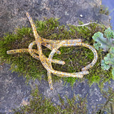Pond Pro Gold Flake Sqworms on a Rock with moss and foliage.