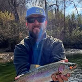 Tim Shannon, Pond Pro Guide holding a trout on Norfork River.