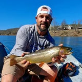 Pond Pro Guide, Tim Shannon, holding a large trout that he caught while on a boat on the Norfork River in Arkansas.