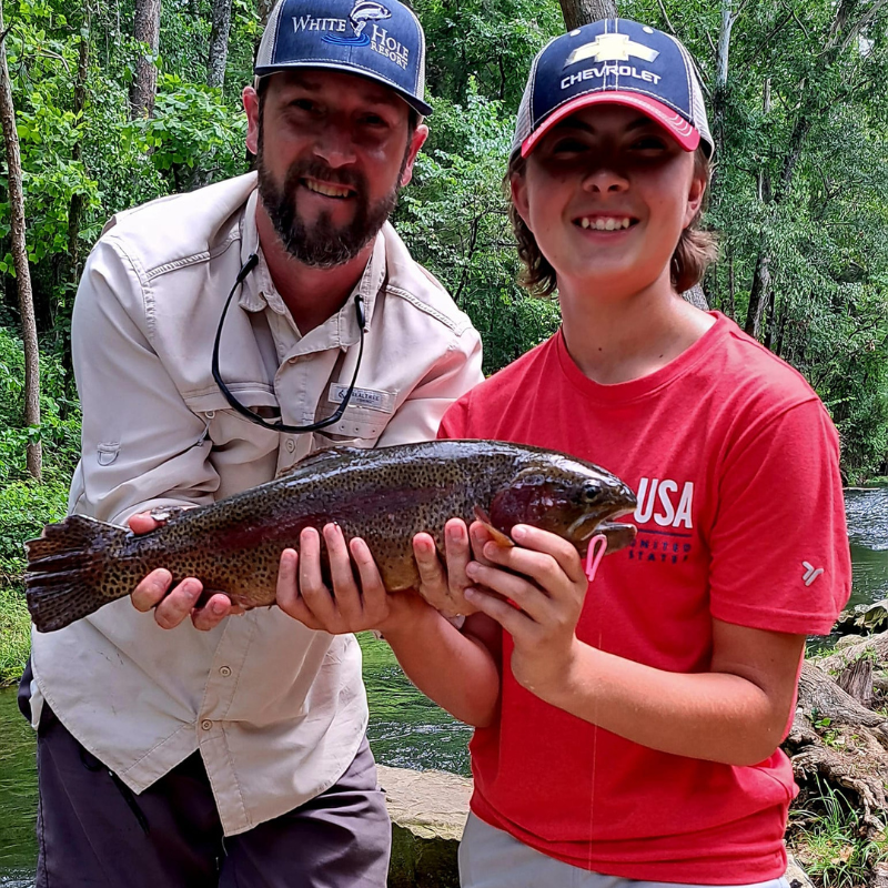 Pond Pro Guide Tim Shannon with boy holding fish while fishing at Dry Run Creek