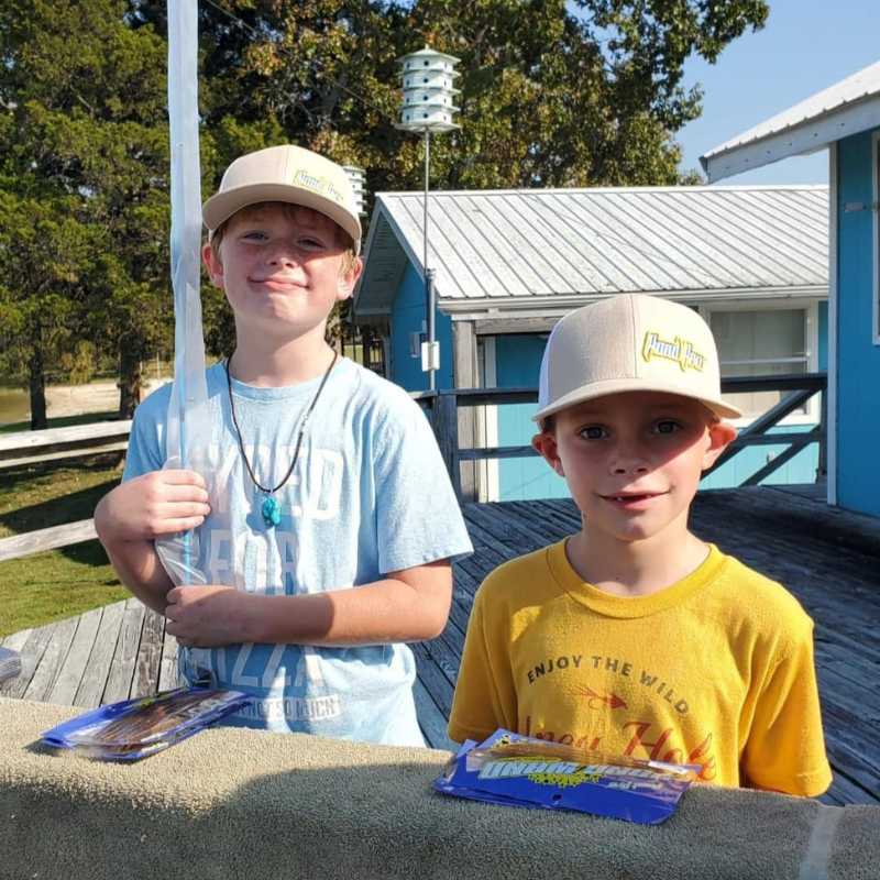 Two boys with Pond Pro baits and hats.
