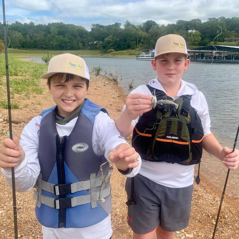 Two young boys fishing while wearing Pond Pro Hats in Khaki color.