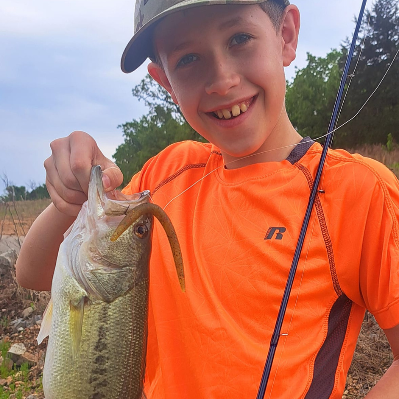 Young boy holding fish caught using Pond Pro Pond Wand