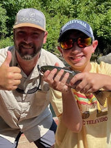 A young boy on a guide trip with Pond Pro, Tim Shannon, at Dry Run Creek in Arkansas.