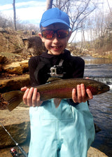 Proud young boy holding a large trout at Dry Run Creek in Arkansas.