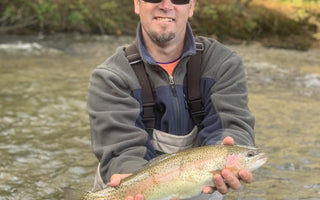 Pond Pro, Tim Shannon, holding a rainbow trout on the Oconaluftee River