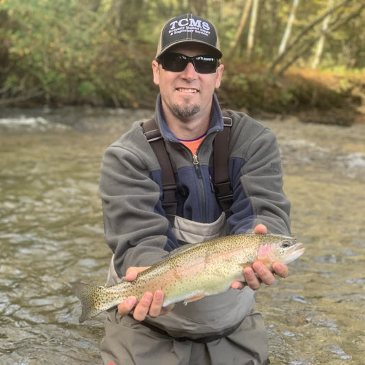 Pond Pro, Tim Shannon, holding a rainbow trout on the Oconaluftee River