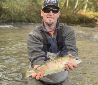 Pond Pro, Tim Shannon, holding a rainbow trout on the Oconaluftee River