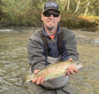 Pond Pro, Tim Shannon, holding a rainbow trout on the Oconaluftee River