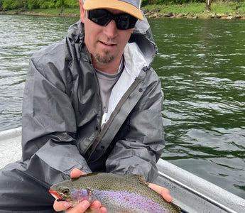 Pond Pro, Tim Shannon, holding a rainbow trout on the North Fork River