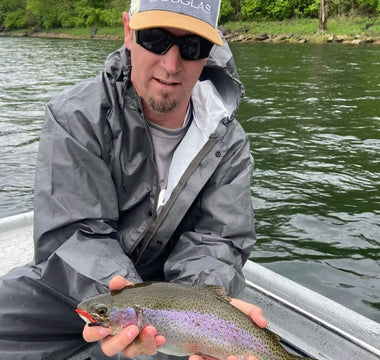 Pond Pro, Tim Shannon, holding a rainbow trout on the North Fork River
