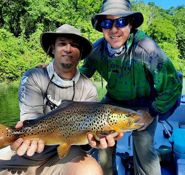 Pond Pro, Tim Shannon and George Hill, holding a brown trout on the North Fork River