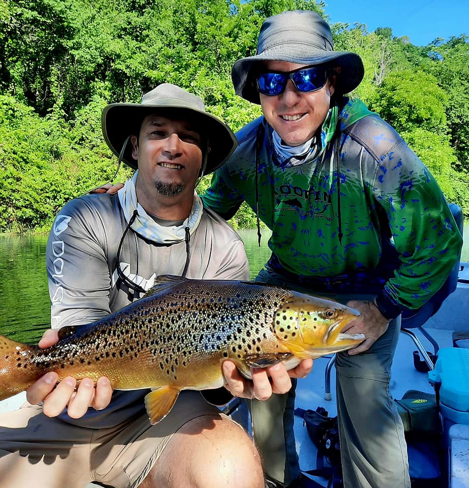 Pond Pro, Tim Shannon and George Hill, holding a brown trout on the North Fork River