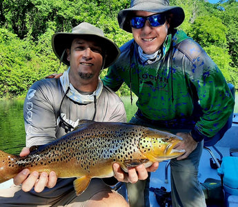 Pond Pro, Tim Shannon and George Hill, holding a brown trout on the North Fork River