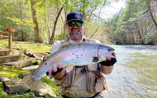 Pond Pro, Michael Willett, holding a large rainbow trout on Fightingtown Creek