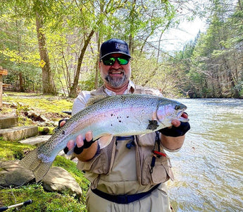 Pond Pro, Michael Willett, holding a large rainbow trout on Fightingtown Creek