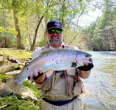 Pond Pro, Michael Willett, holding a large rainbow trout on Fightingtown Creek