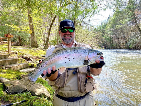 Pond Pro, Michael Willett, holding a large rainbow trout on Fightingtown Creek