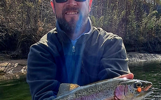 Pond Pro Guide Tim Shannon holding trout caught with orange scorn