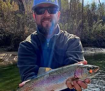 Pond Pro Guide Tim Shannon holding trout caught with orange scorn