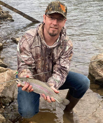 Pond Pro Guide, Tim Shannon, holding a trout in the Spring River in Arkansas.