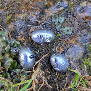 Three Pond Pro Up-Shot weights on a stone surface.