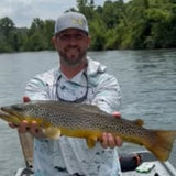 Pond Pro Guide, Tim Shannon, holding a large trout on the White River in Arkansas.