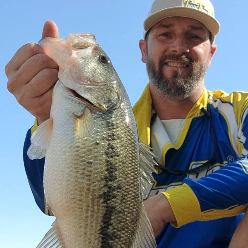Pond Pro Tim Shannon holding a bass.
