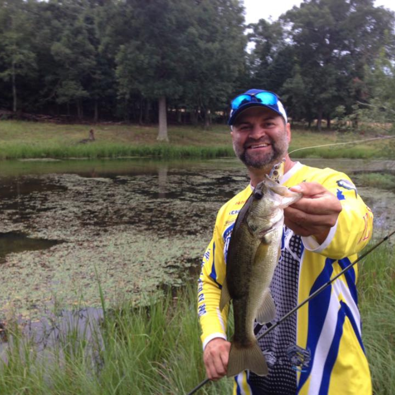 Pond Pro Tim Shannon holding a bass.